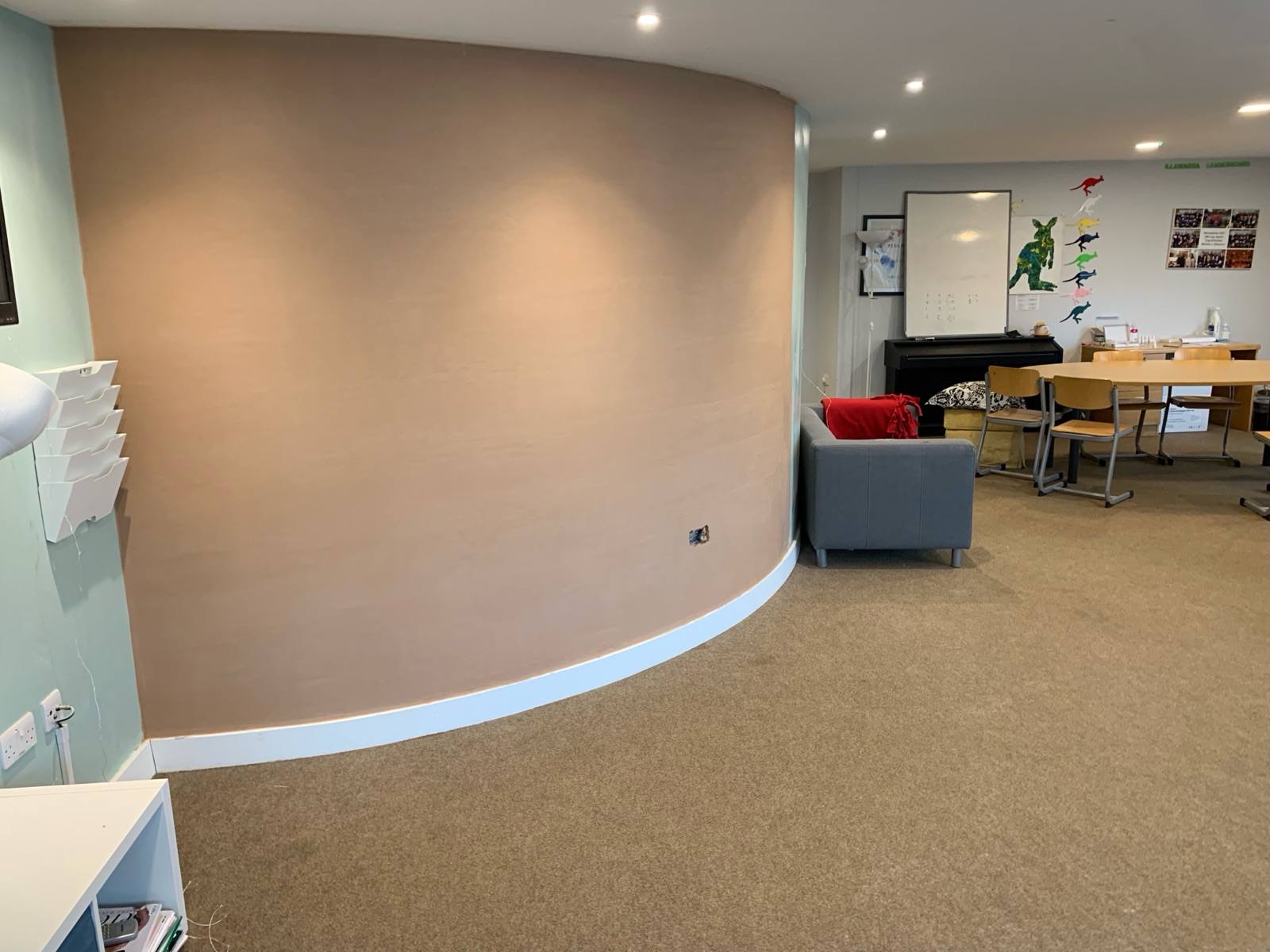 A sweeping curved wall freshly skimmed flat by Eagle Plastering — the firm's own work